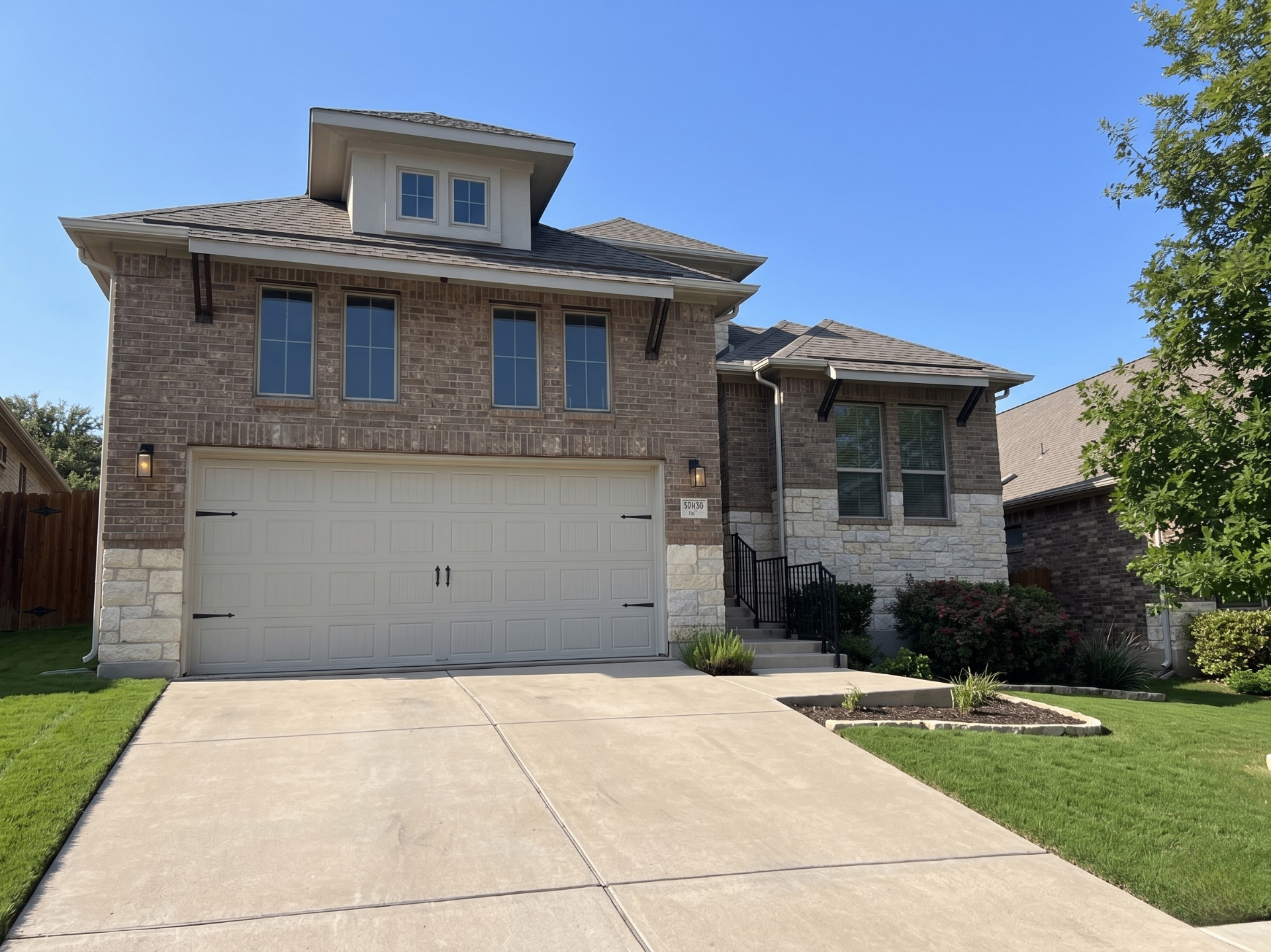 Side view of the home showing landscaping and architectural details
